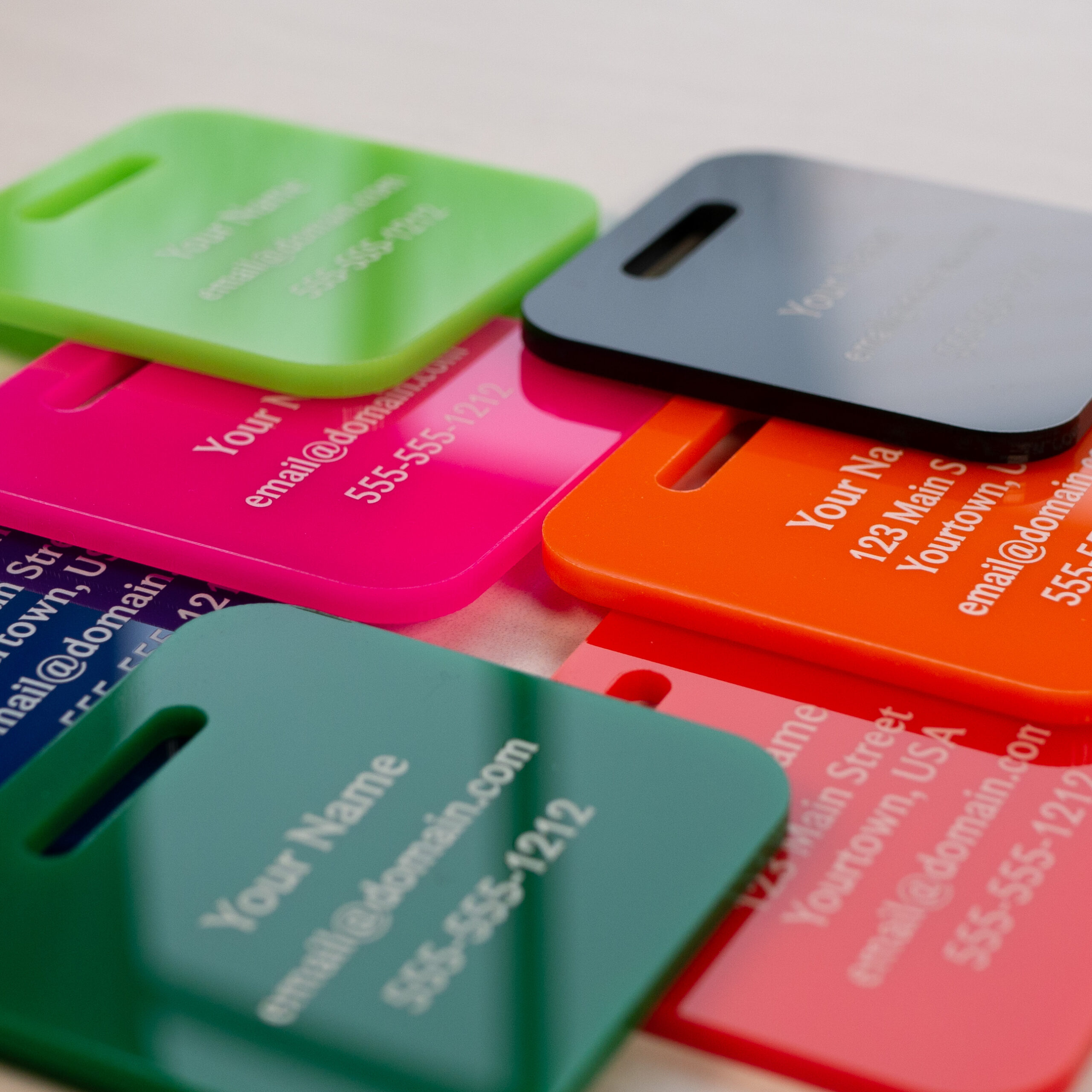 stack of luggage tags with lime green on top